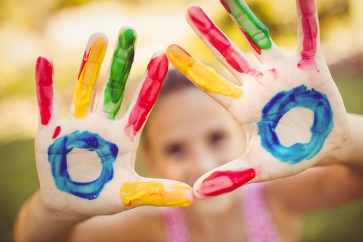 pikwizard-little-girl-making-a-triangle-with-her-painted-hands-t